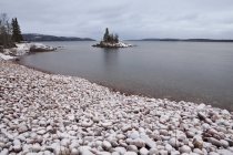 Playa de guijarros en el lago - foto de stock