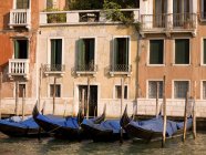 Gondolas in a row in water — Stock Photo