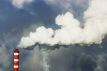 Chimney with smoke against sky — Stock Photo