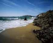 Sandy beach with rocks — Stock Photo