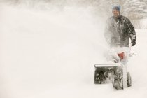 Caucasian male worker with snow-blowing — Stock Photo