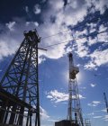 Drilling Rigs against cloudy sky — Stock Photo