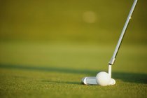 Cloesup of ball, hole and club on golf course — Stock Photo