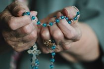 Rosary Beads In Hand — Stock Photo