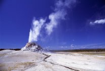 Erupting Geyser  from small hill — Stock Photo