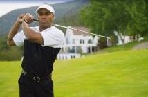 African american golfer at course with golf club — Stock Photo