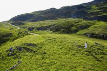 Distant View Of Man Walking On Hillside — Stock Photo