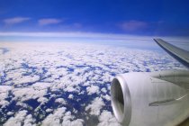 Airplane In Flight over clouds — Stock Photo