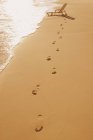 Sandy beach with footsteps — Stock Photo