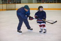 Entrenador y jugador de hockey en el hielo - foto de stock