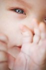 Vue rapprochée du visage et des mains de bébé — Photo de stock