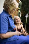 Grandmother with granddaughter dressed up as princess looking at each other — Stock Photo