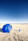 Sandy beach with unbrella — Stock Photo