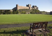 Bench Across The Lawn From A Castle — Stock Photo