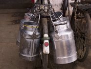 Крупный план изображения молочных кувшинов на велосипеде — стоковое фото