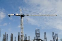 Crane At Work against construction — Stock Photo