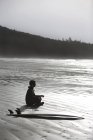 Surfer Meditating On Beach — Stock Photo