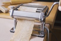 Pasta Machine With Brown Pasta Sheet Rolling Out — Stock Photo