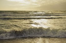 Волны океана на закате — стоковое фото
