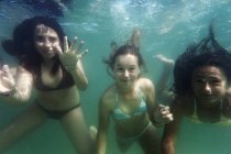 Teen girls swimming underwater — Stock Photo