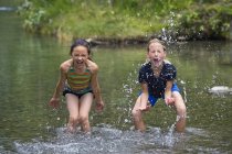 Two happy caucasian Girls Playing In Water — Stock Photo