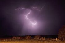 Lightning bolt over some abandoned buildings — Stock Photo