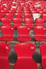 Assentos vermelhos em filas com números — Fotografia de Stock