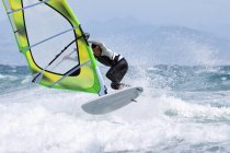 Adult extreme athlet on windsurfing board. Tarifa, Cadiz, Andalusia, Spain — Stock Photo