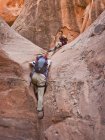 People exploring a slot canyon; Hanksville Utah united states of america — стоковое фото