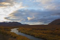 Blackstone river flows through colourful tundra — Stock Photo