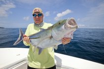 Человек держит свежепойманную рыбу, Панама — стоковое фото