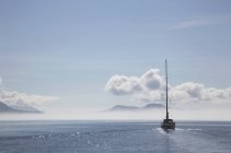 Sailboat cruises on a sunny day — Stock Photo