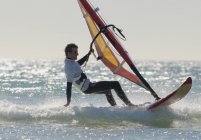 Atleta extremo adulto en tabla de windsurf. Tarifa, Cádiz, Andalucía, España - foto de stock