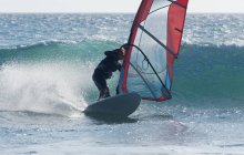 Adult extreme female athlet on windsurfing board. Tarifa, Cadiz, Andalusia, Spain — Stock Photo