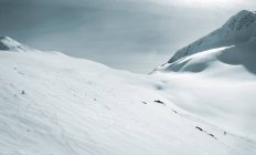 Skier Dwarfed By Mountain — Stock Photo