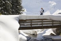 Female Snowshoeing On Bridge — Stock Photo