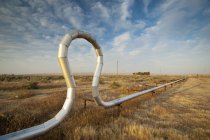 Pipe In A Unique Shape In A Grassy Area; Mckittrick, California, United States of America — стоковое фото