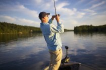Rear view of fisherman with fish on his line — Stock Photo