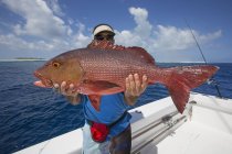 Fisherman on boat holding fresh caught Red Snapper — Stock Photo