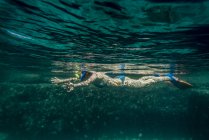 Side view of woman swimming under water with swimming mask — Stock Photo