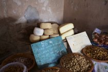 Artisan cheese and olives on sale on covered market stall — Stock Photo