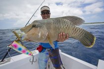 Fisherman holding fresh caught Napoleon Wrasse. Tahiti — Stock Photo