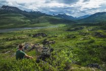 Man sitting overlooking — Stock Photo