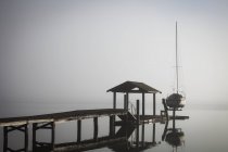 Sailboat on lift by dock — Stock Photo