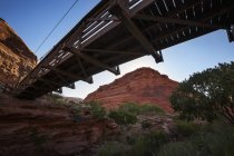 Footbridge spanning a canyon stream — Stock Photo