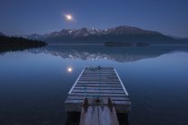 Boat dock with a full moon — Stock Photo