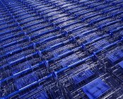 Stacks of metal shopping trolleys background — Stock Photo