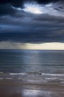 Storm against sandy beach — Stock Photo