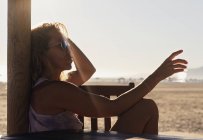 Жінка сидить на A пляж денний час — стокове фото