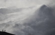 Fotografi Silhouetted Against The Snow Laden Mountain; Islanda — Foto stock